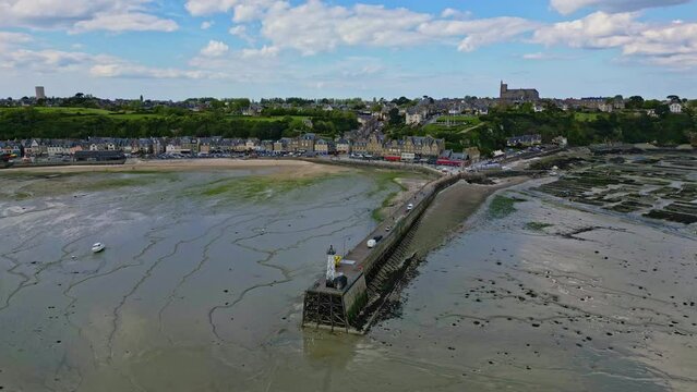 Cale de la Fenetre pier and beach during low tide, Brittany in France. Aerial drone panoramic view