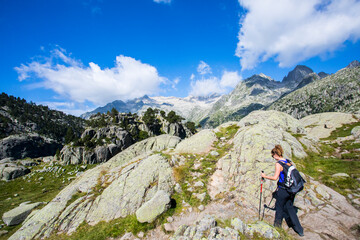 Fototapeta premium Young hiker woman in Vall de Boi, Aiguestortes and Sant Maurici National Park, Spain