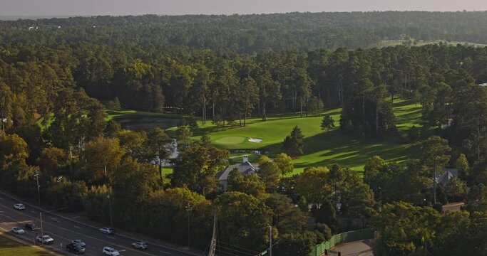 Augusta Georgia Aerial v30 low birds eye view, flyover capturing the landscape of National Golf Club with pristine lake environment and intricate course layout - Shot with Inspire 3 8k - October 2023