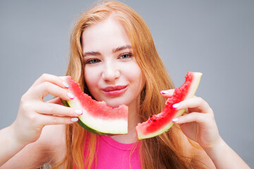 Hungry and happy young beautiful woman with peels from eating watermelon isolated on white...