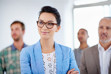 Smile, thinking and business woman with team in office for collaboration, management or meeting....