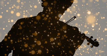 Image of light spots moving over silhouette of man playing violin