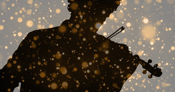 Image of light spots moving over silhouette of man playing violin