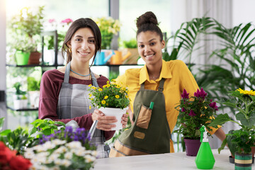 Young florists working together and smiling