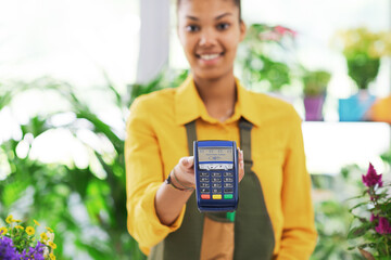 Smiling florist holding a POS terminal