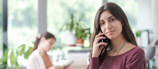 Professional young woman having a phone call