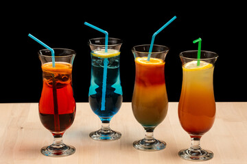 Close-up of vibrant cocktails with straws on a tabletop