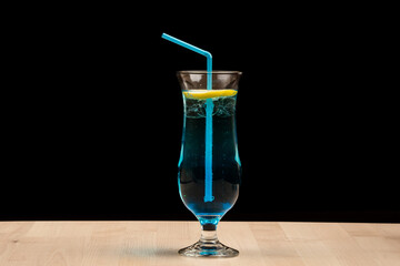 Glass of lemonade with a citrus slice on a wooden table