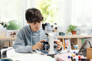 Happy student using a microscope