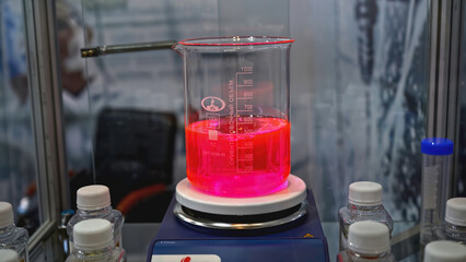 Rotating colored liquid in laboratory container. Media. Laboratory examination with colored liquid...