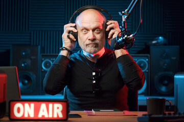 Surprised radio presenter working in the studio