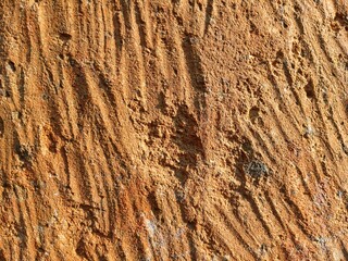 Old dry veil stone texture in earthy orange color for background and prop material