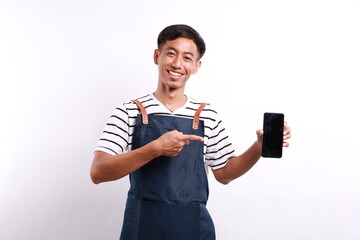 Young smiling asian man barista bartender barman employee in blue apron white t-shirt work in...