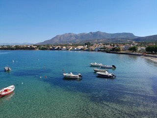 Obraz premium Greek Fishing boards in clear blue water with a blue sky in the background.