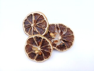 Slices of dried lemon as a herbal ingredient for healthy food and drinks on a blank white background