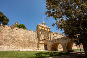 Entrance stone bridge and gate to fortified medieval city Mdina called silent city in the Northern Region of Malta.