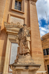 Statue in front of Rotunda of Mosta, Sanctuary Basilica of the Assumption of Our Lady a magnificent domed church, stands as an architectural marvel and iconic landmark in Malta.