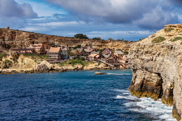 Whimsical Popeye Village in Malta, a film set turned attraction, with its quirky architecture and waterfront charm.