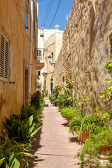 Narrow, winding alleyway in Rabat's ancient core reveals historic sandstone facades and glimpses of Malta's storied past. Rabat, Cultural heritage of Malta,