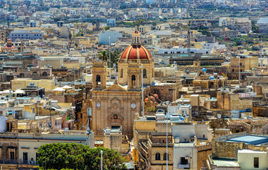 Historic Citadel in Victoria offers a stunning vantage point to view St. George's Basilica amid Gozo's terracotta rooftops. Gozo Malta