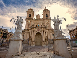 Majestic Zabbar Parish Church in Malta, a symbol of faith and heritage, standing tall against the evening sky at sunset.