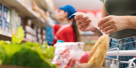 Woman checking the grocery receipt