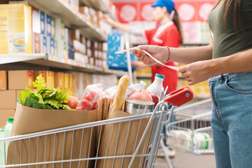 Woman checking the grocery receipt