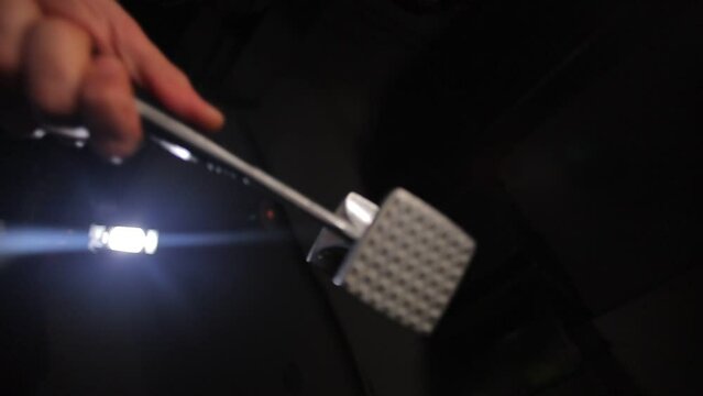Close-up shot of a man bringing a meat tenderizer close to the camera.