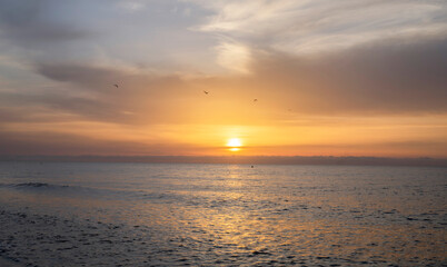 Stunning sunrise with the orange sky as the sun rises over the ocean.