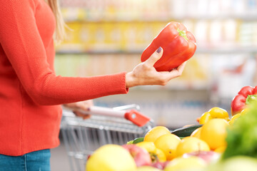 Woman choosing fresh vegetables at the supermarket