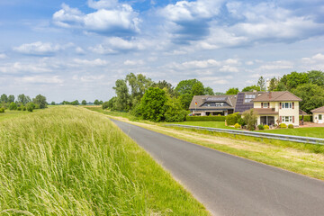Houses behind the dike along the Ems river near Papenburg, Germany