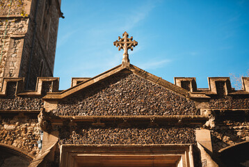 Cross atop a steeple on a building.