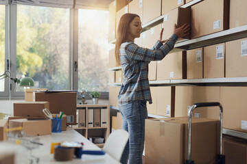 E-commerce employee taking boxes from the shelves