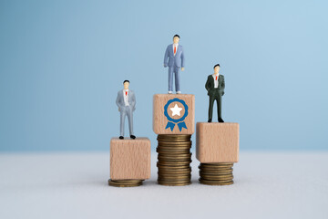 miniature of businessman stand on wooden cube block and guarantee symbol over stack of coins