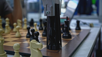 Man is playing chess with robot. Media. Man is playing chess against robot at exhibition....