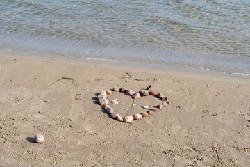 Scenic view of pebbles forming a heart on a sandy beach
