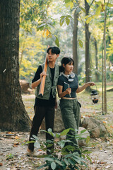 Asian couple sweet in tent inside on they camping trip, traveller relax and sleep togather in out door and camping trip