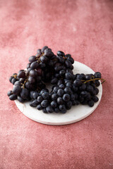Dark grape on a white desk