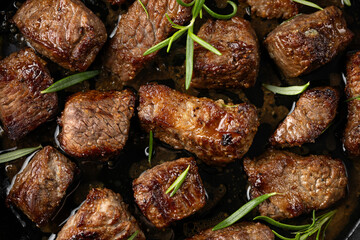 Garlic butter beef steak bites in iron cast pan