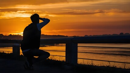 Photograph a striking silhouette of a person against the backdrop of a fiery sunset, capture the dramatic contrast of the human form against the vibrant hues of dusk, embrace the artistry of shadow 