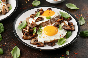 Mushrooms and fried eggs on toast with herbs breakfast