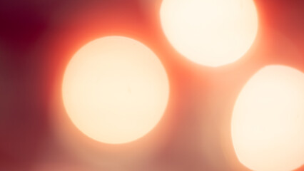 Golden and red bokeh lights create a soft, dreamy background
