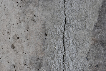Texture of old cracked concrete wall. Rough gray concrete surface. The gap between the reinforced concrete slabs. Perfect for background and design. Close-up. High resolution.