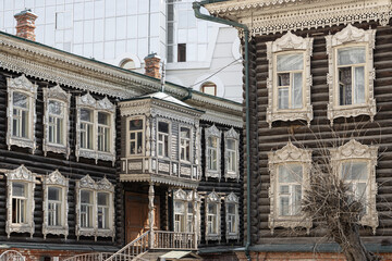 Beautiful old wooden houses with traditional carved frames. Tomsk city, Tomsk region, Siberia, Russia.