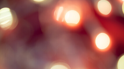 Golden and red bokeh lights create a soft, dreamy background