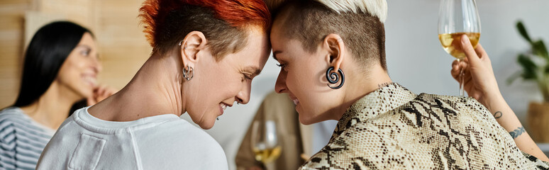 Two lesbians posing closely side by side, with friends.