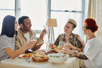 Diverse group of friends, including a loving lesbian couple, sharing a meal at a home dining table.