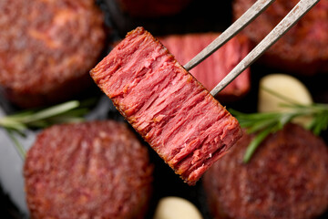Slices of plant based vegan meat steak on meat fork. Alternatives meat. Eco friendly healthy food,