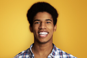 Healthy Teeth. African Guy with Beaming Smile, Looking at Camera on Orange Background