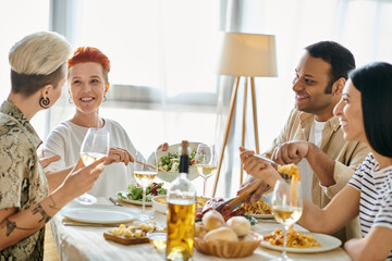 A diverse group of friends enjoy a meal together at a dinner table hosted by a loving lesbian couple.